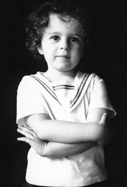 Lily Casura as a young child, arms crossed