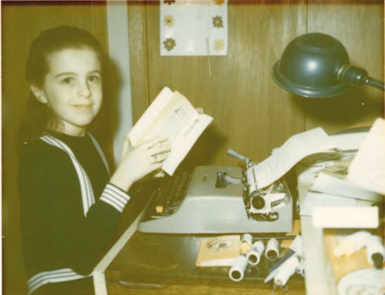 Lily Casura at a typewriter, young